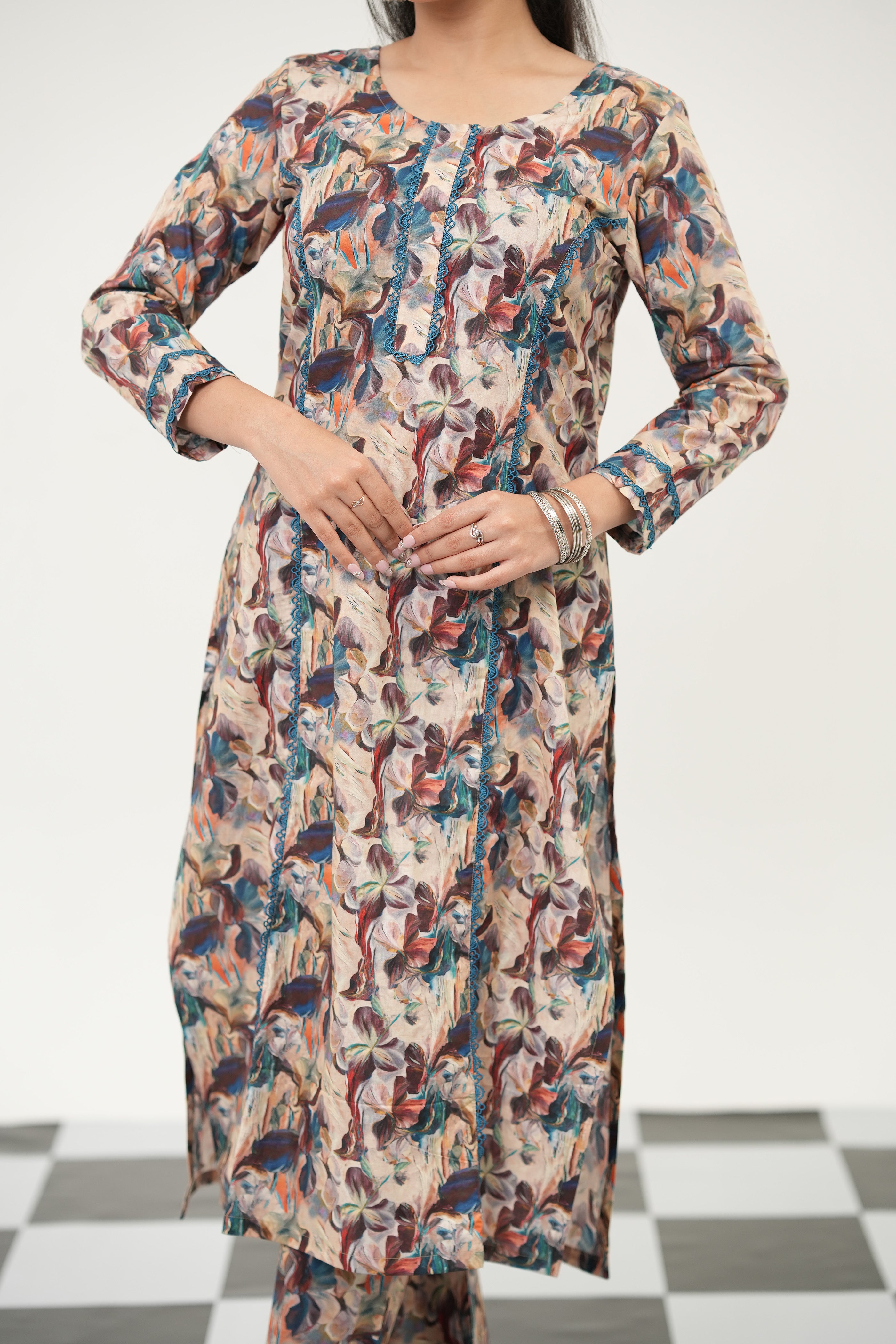 A woman wearing a SIMROZ abstract kurta set featuring vibrant digital print, straight-fit silhouette, and 3/4 sleeves