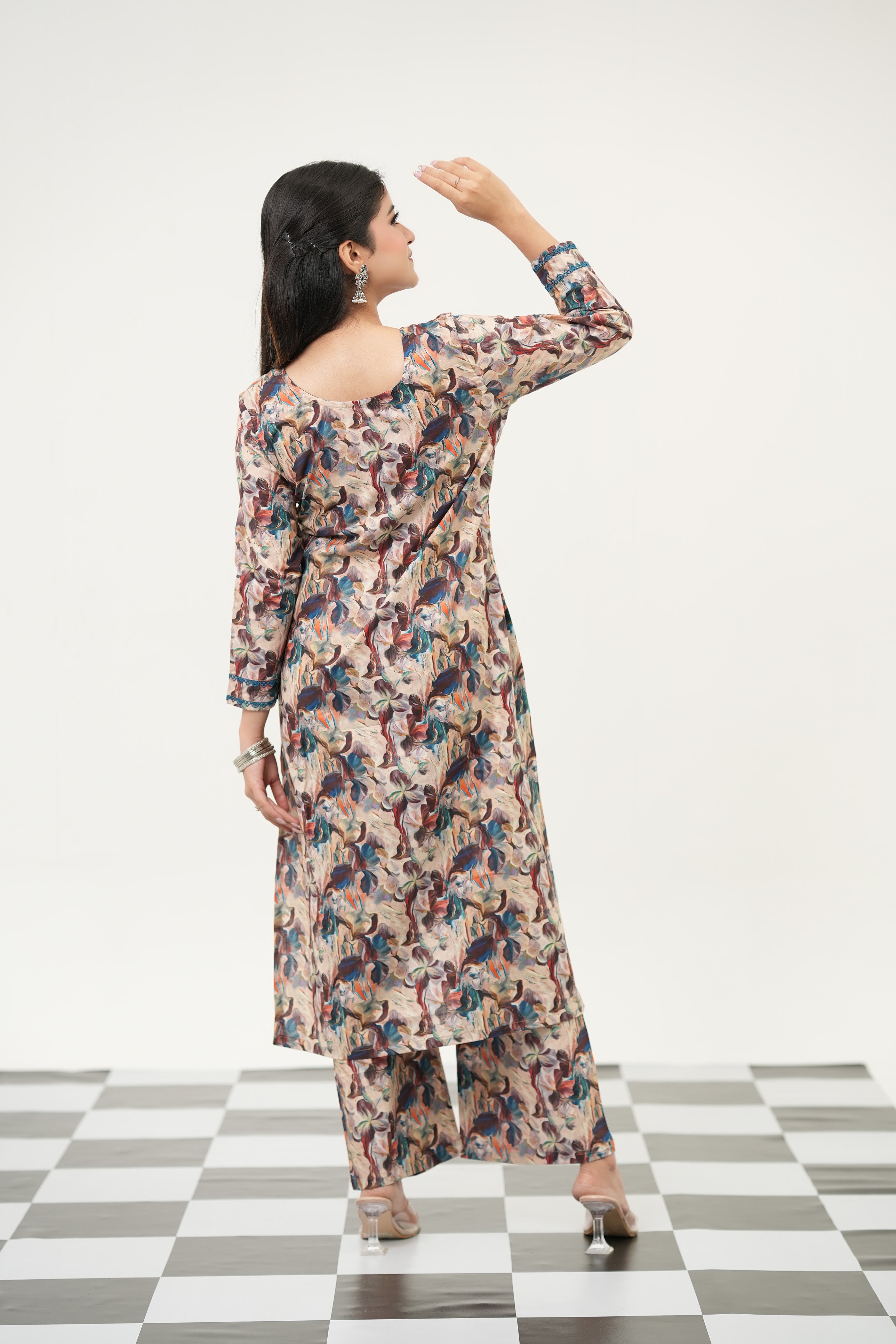 Abstract digital print kurta set by SIMROZ, designed with vibrant painterly florals, intricate lace detailing, 3/4 sleeves, and comfortable cotton cambric fabric, back view.