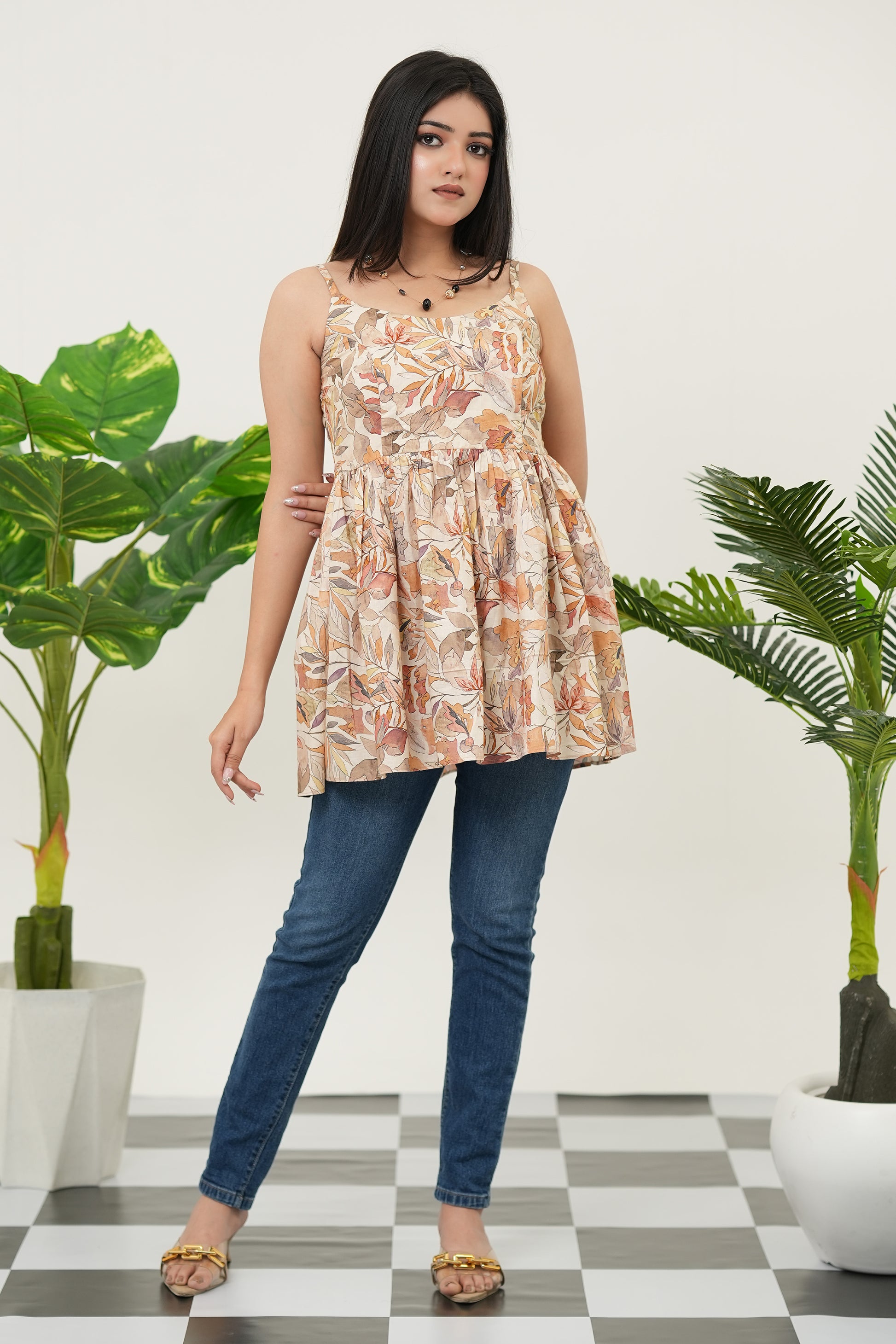Full front standing view of Autumn Whispers Sleeveless Top for women in beige cotton cambric, featuring gathered silhouette, sleeveless cut, wide neckline, and elegant autumn-inspired digital prints - Simroz.