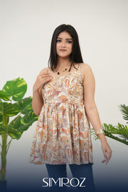 Front view of Autumn Whispers Sleeveless Top for women in beige cotton cambric fabric, featuring gathered style, sleeveless design, delicate digital autumn leaf print, and a chic standing pose for a stylish summer look - Simroz.