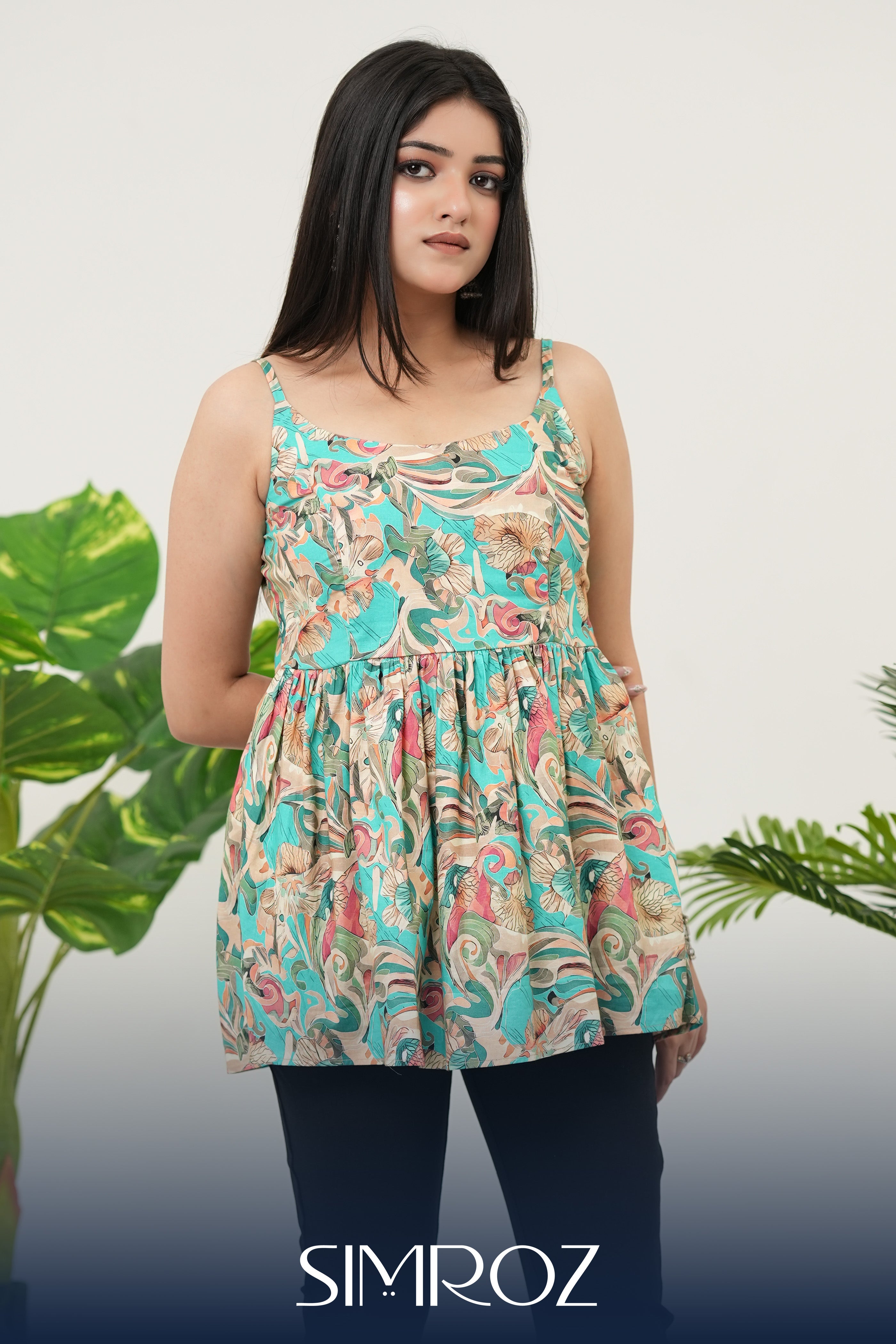 Aqua Breeze Tie-Shoulder Top for women in teal blue cotton cambric fabric, featuring a gathered style, sleeveless design, and vibrant digital print; model posing front-facing in a casual standing position, photographed at eye-level angle for a chic summer look.