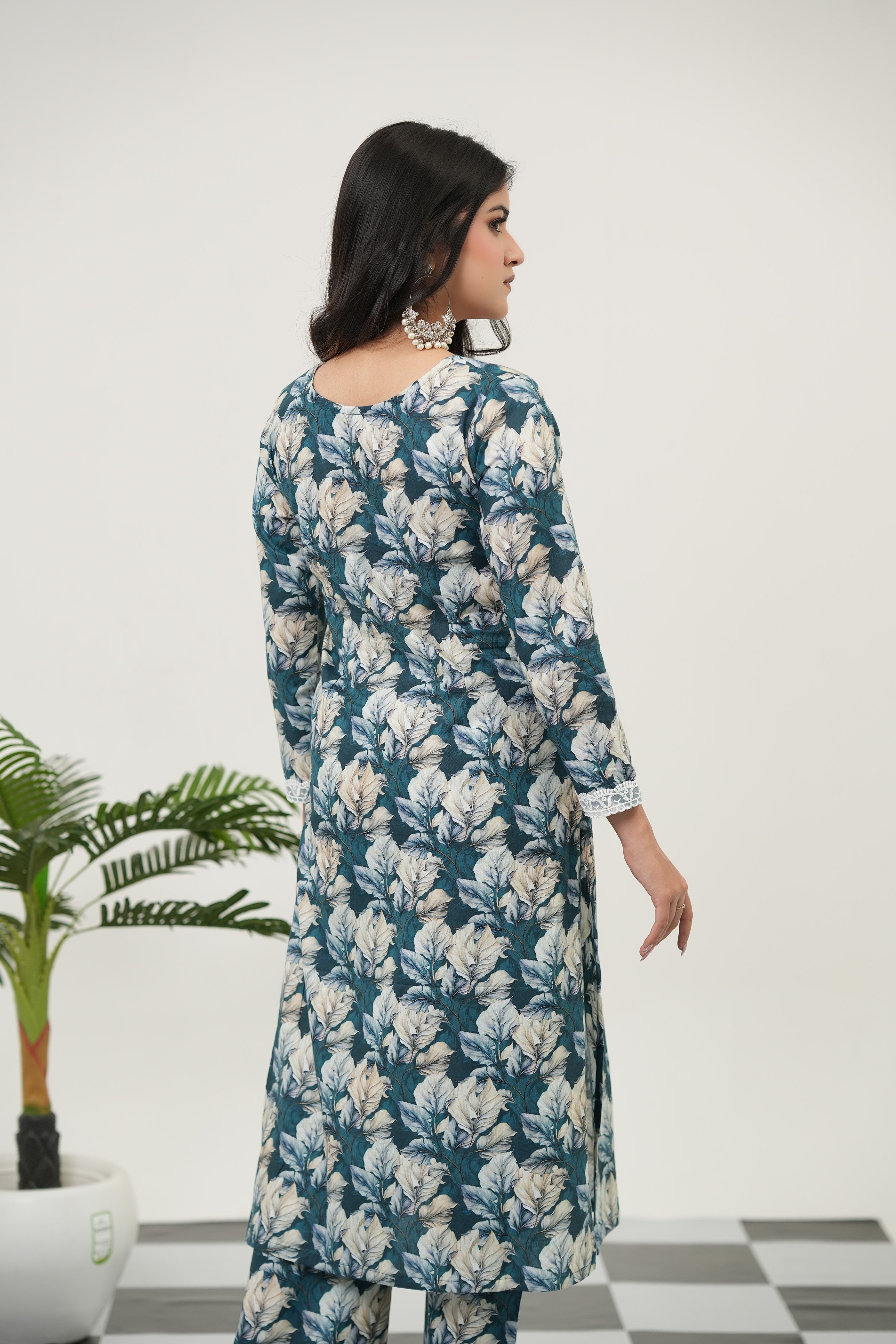 Verdant Bloom blue digital print kurta set by SIMROZ, crafted in premium cotton cambric with lush teal foliage, ivory blossoms, blush florals, straight-fit silhouette, and 3/4 sleeves - back view.