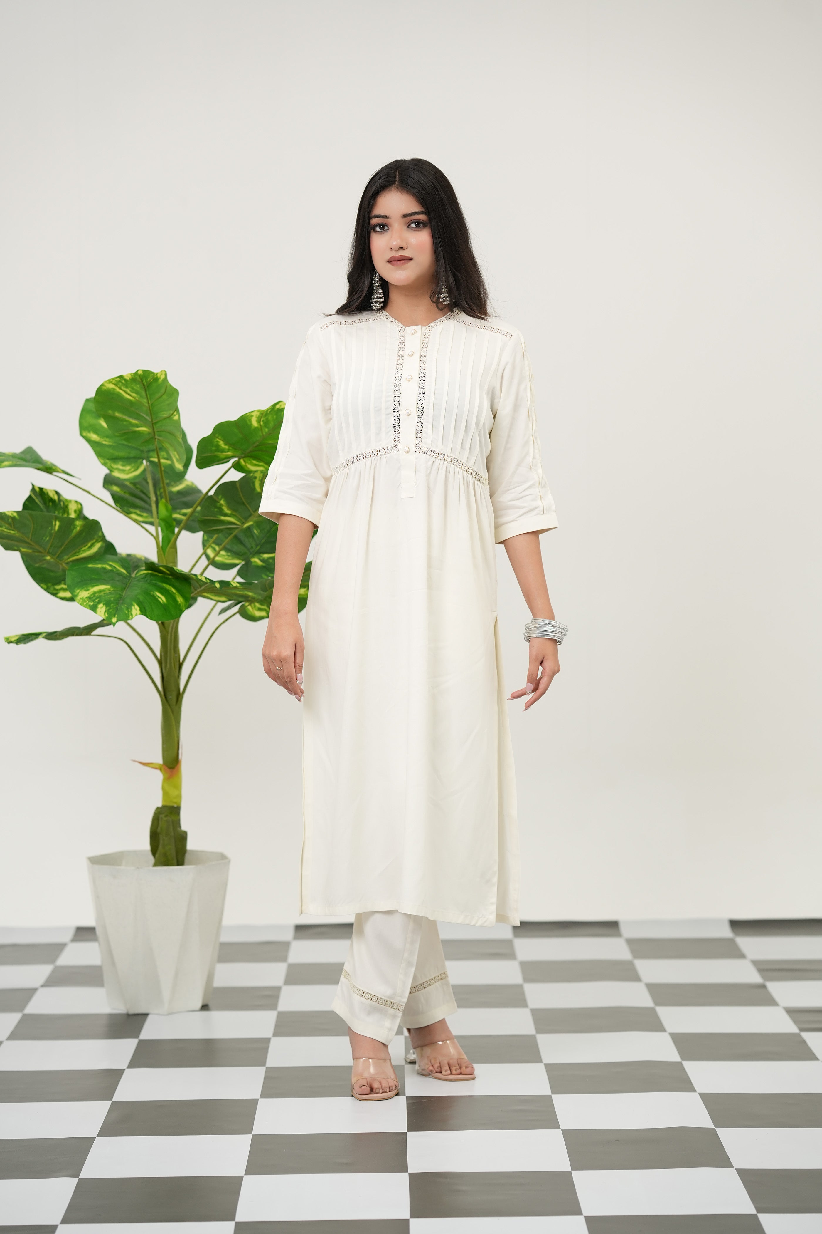 Elegant off-white rayon viscose kurta set featuring textured fabric, lacework neckline, and delicate pintuck design, full view.