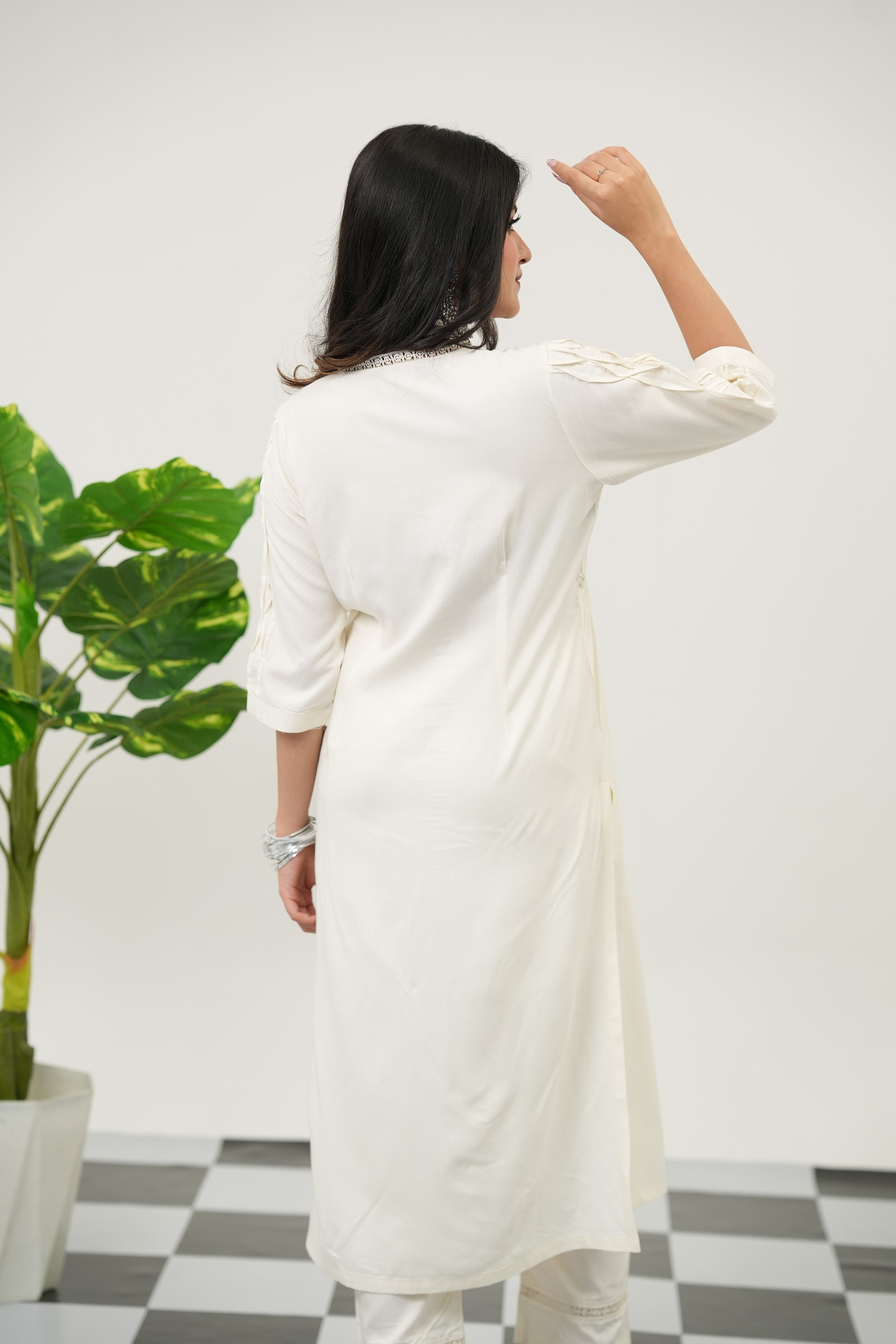 Stylish off-white kurta set with intricate lacework, pintuck front detailing, and soft rayon viscose fabric, back view - Simroz.