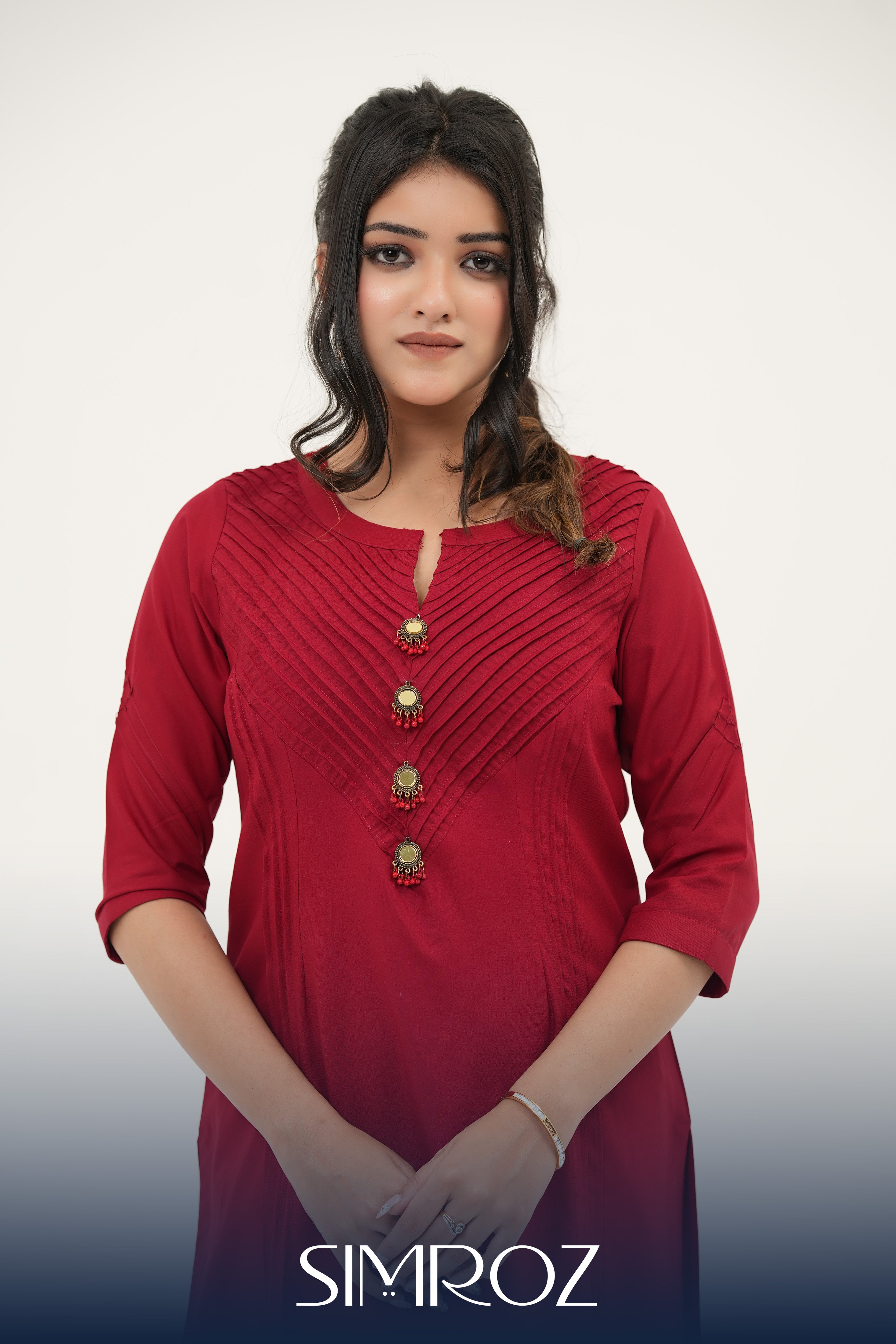 Crimson Radiance red pintuck kurta set with handcrafted mirror and pearl buttons by SIMROZ