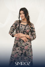 A woman posing in a Twilight Bloom black printed kurta set with vibrant floral digital print and lace detailing by SIMROZ.