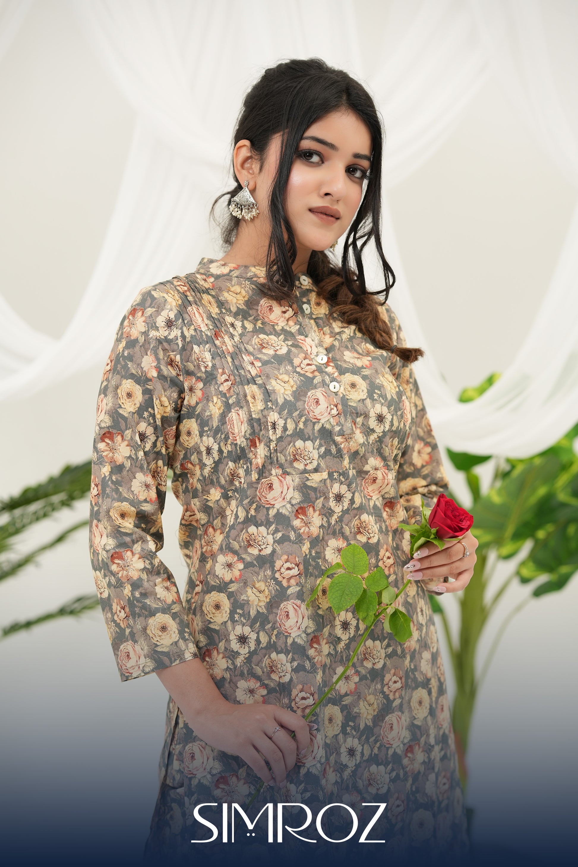A woman wearing a Desert Bloom printed kurta set by SIMROZ featuring delicate floral digital prints on soft grey-beige cotton cambric fabric.