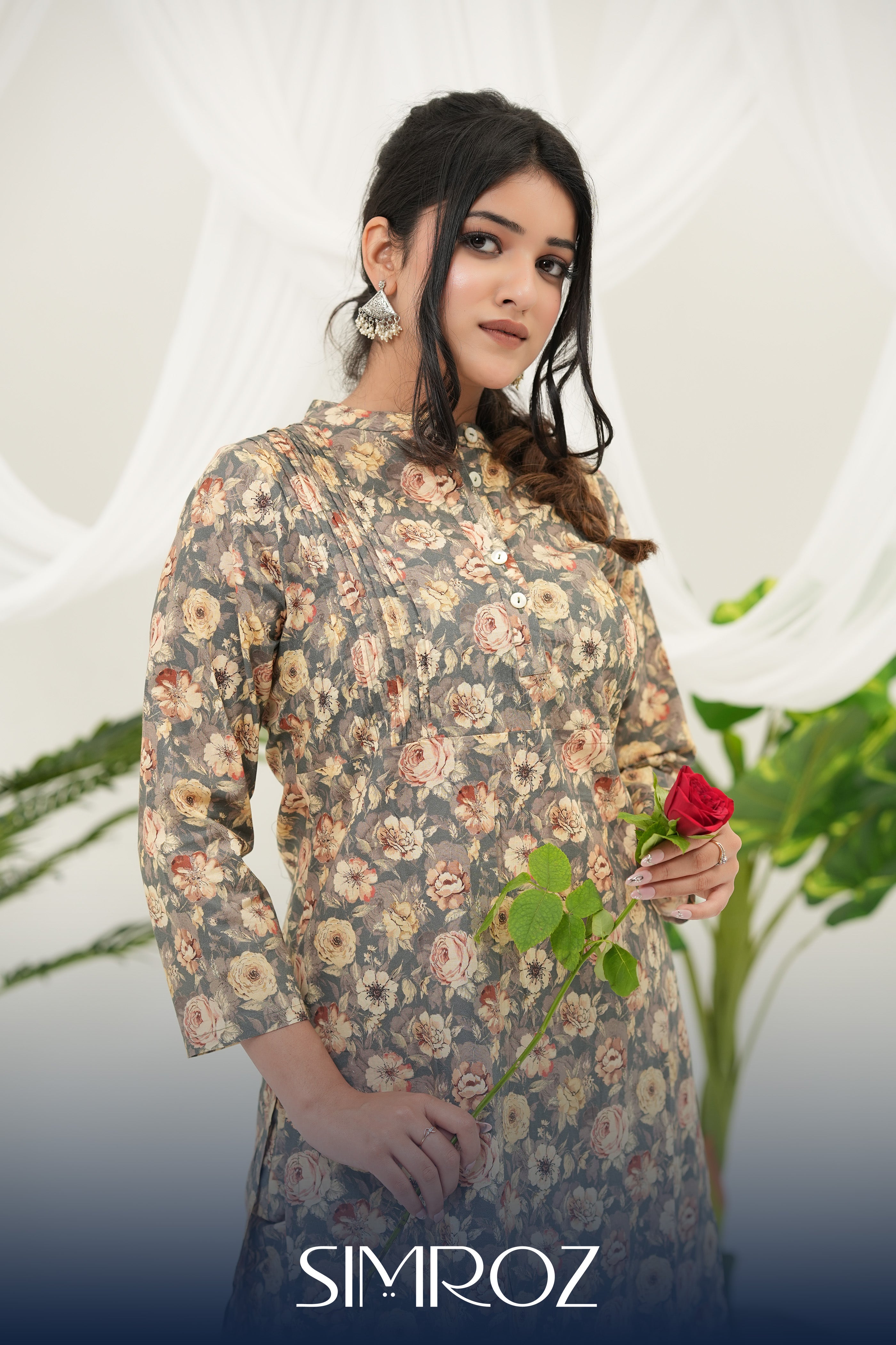 A woman wearing a Desert Bloom printed kurta set by SIMROZ featuring delicate floral digital prints on soft grey-beige cotton cambric fabric.