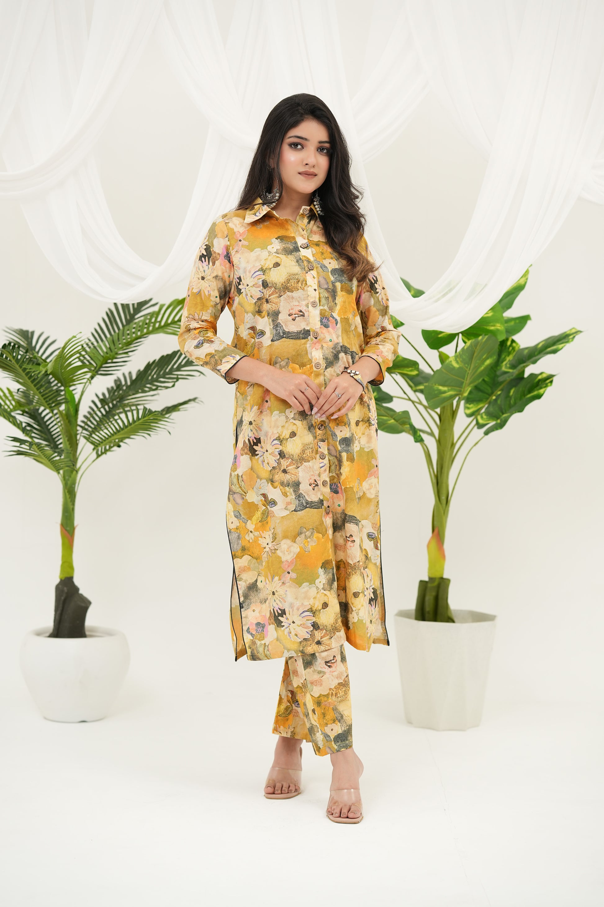 A woman Simroz Golden Meadow kurta set featuring teal, peach, and cream digital patterns and three-quarter sleeves.