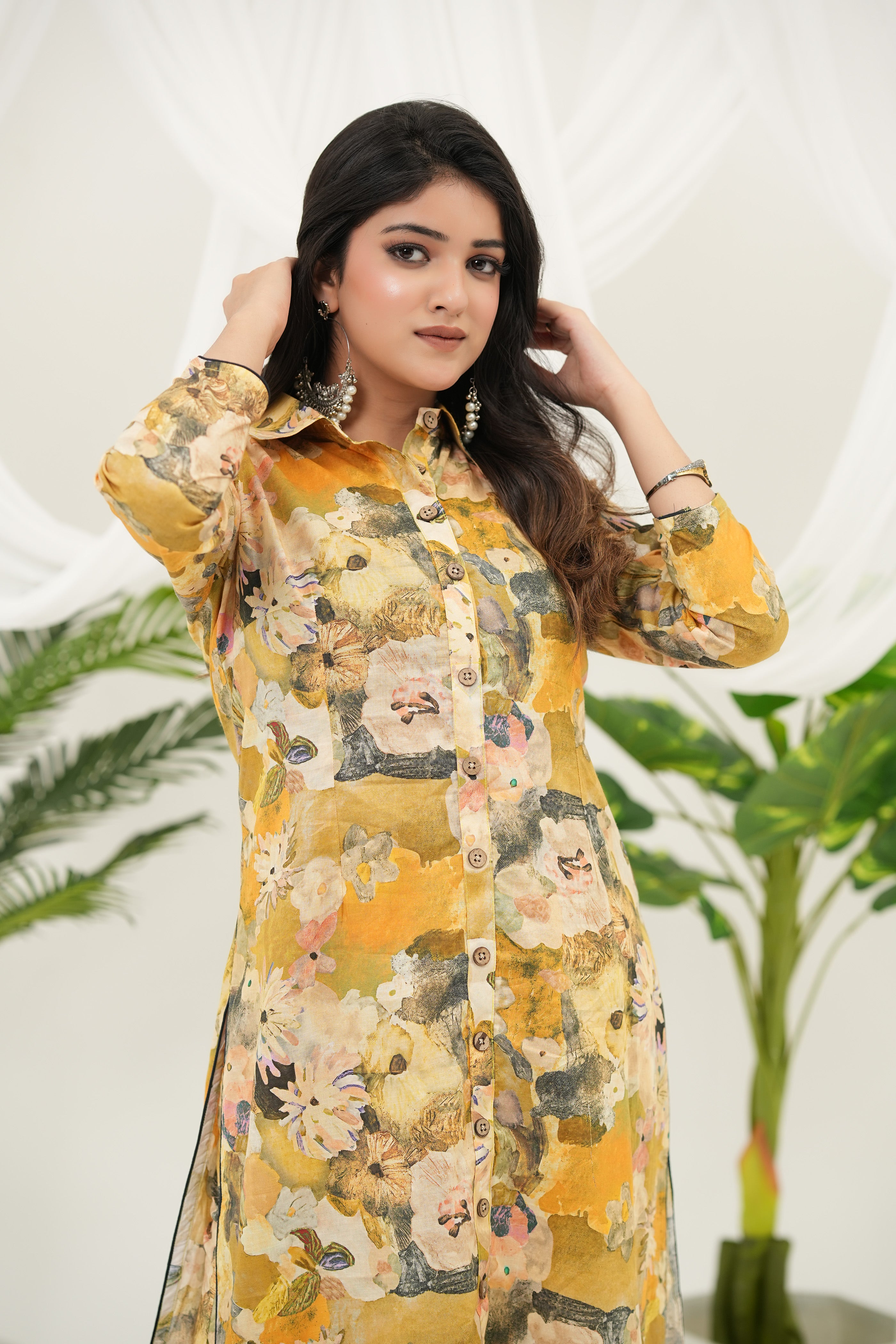 A woman standing and wearing Cotton cambric kurta set with button-down placket and floral digital designs – Simroz