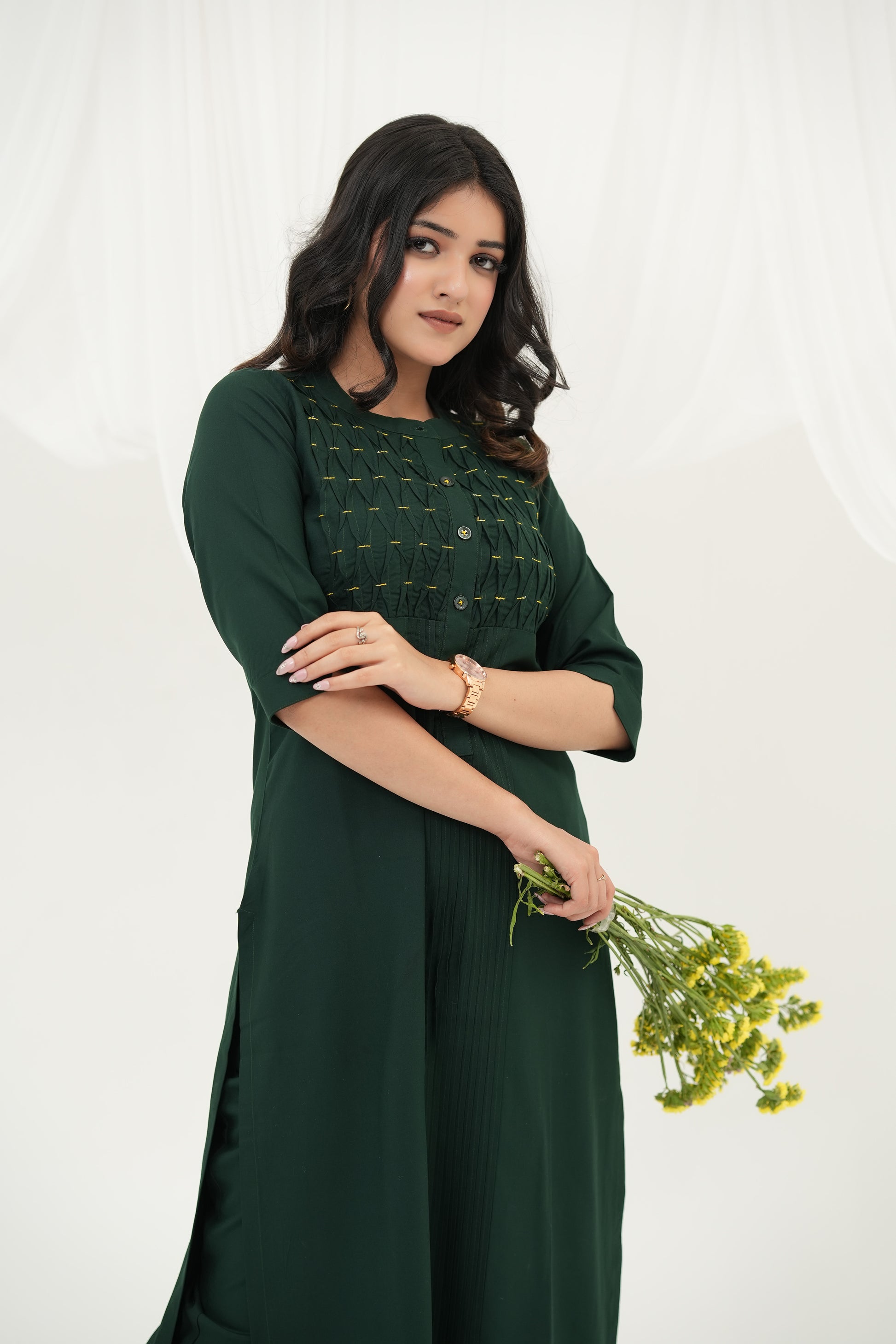 Deep emerald green kurta set with pintuck detailing, button-down placket, and handcrafted bead embellishments by SIMROZ