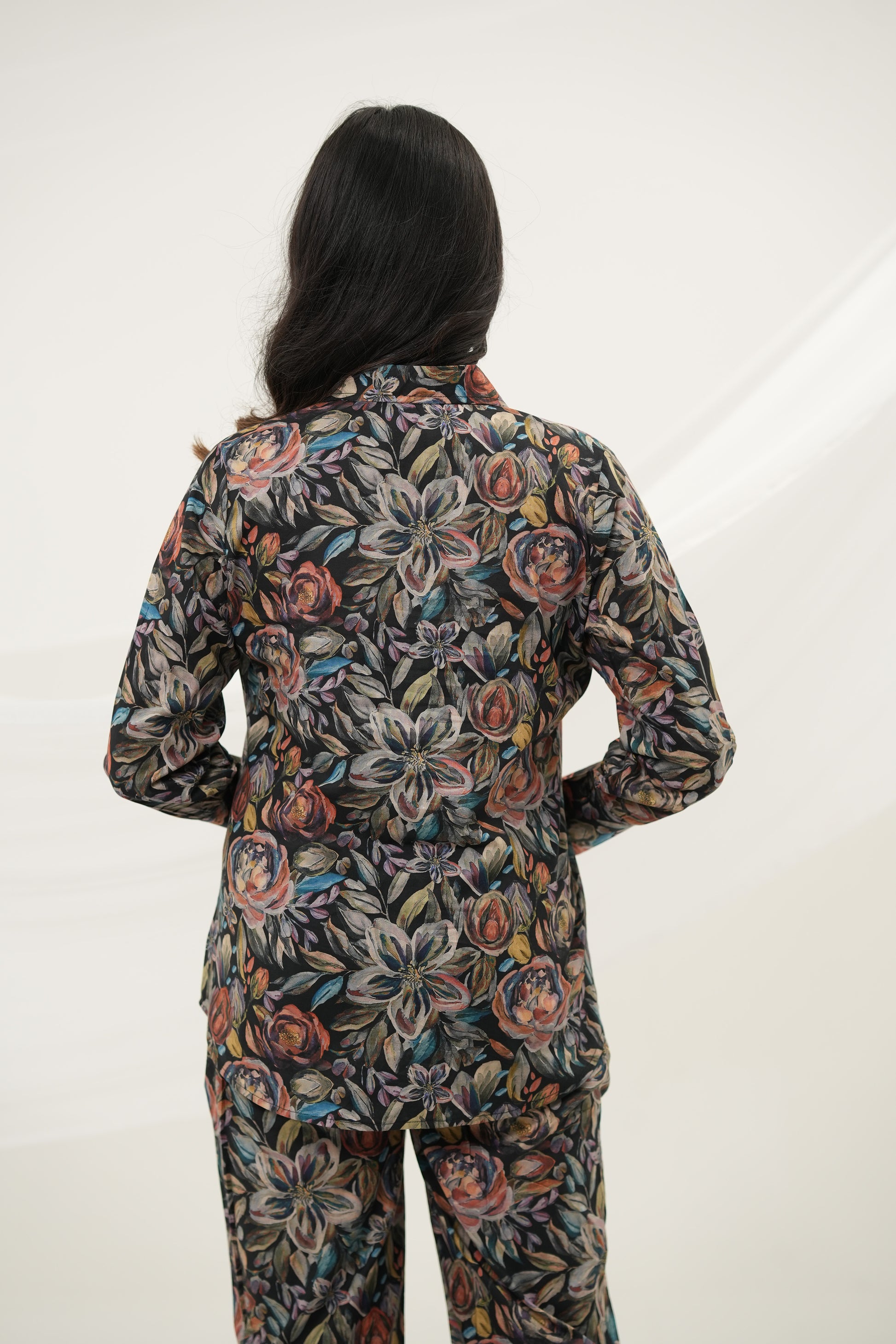 A woman wearing Black Multiflora Co-ord Set with pockets, back view - Simroz.