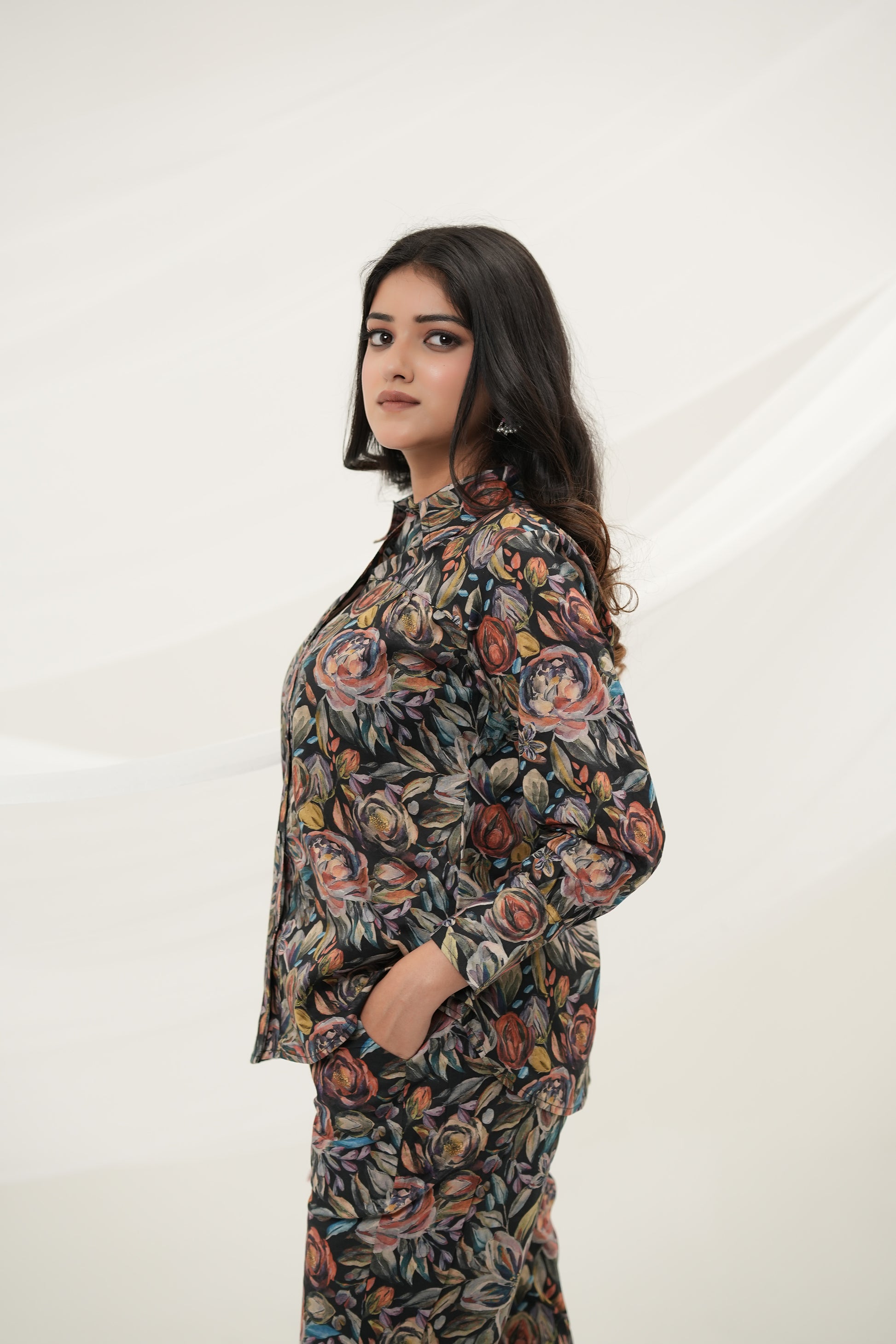A woman wearing Black Multiflora Co-ord Set with pockets, side view - Simroz.