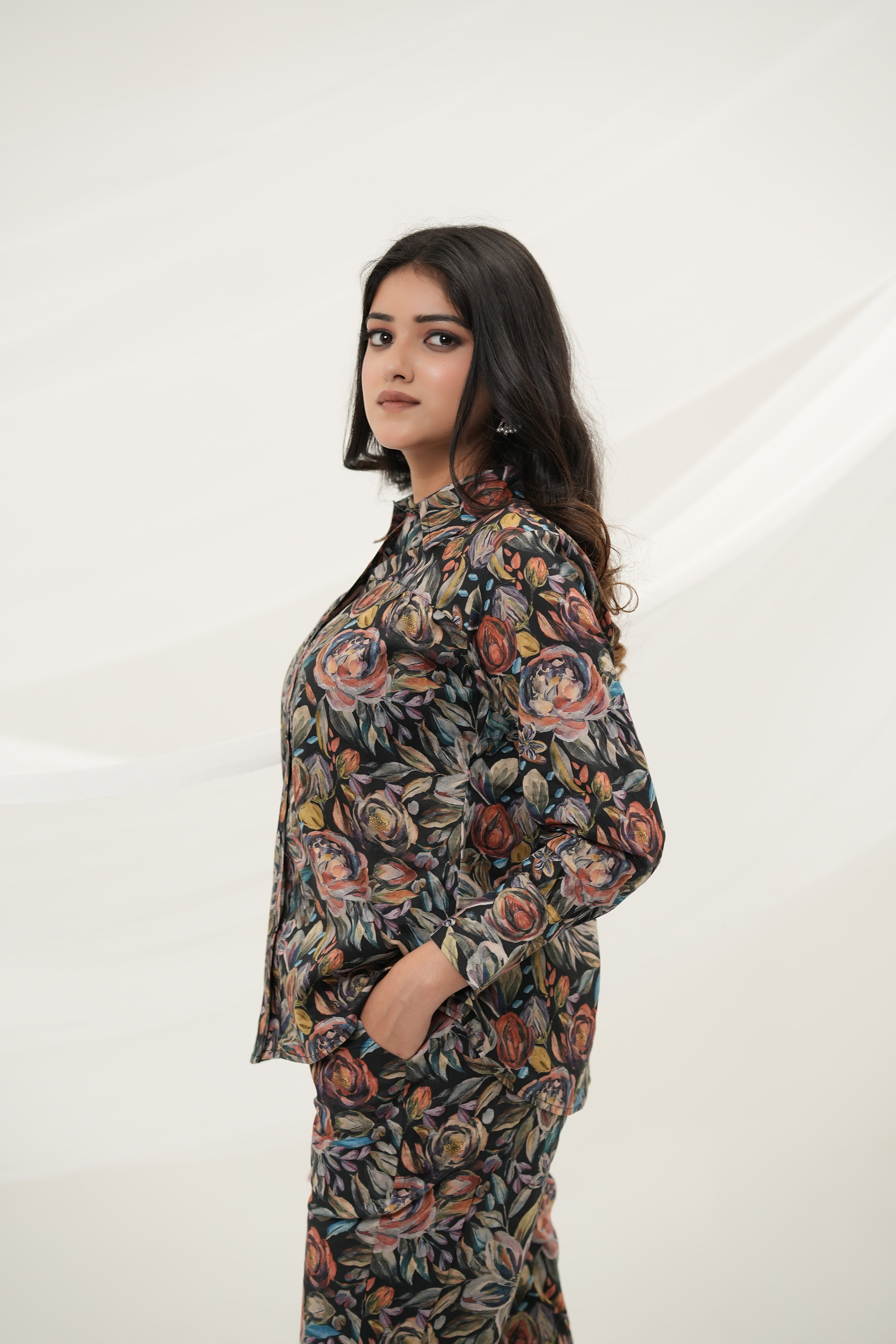 A woman wearing Black Multiflora Co-ord Set with pockets, side view - Simroz.