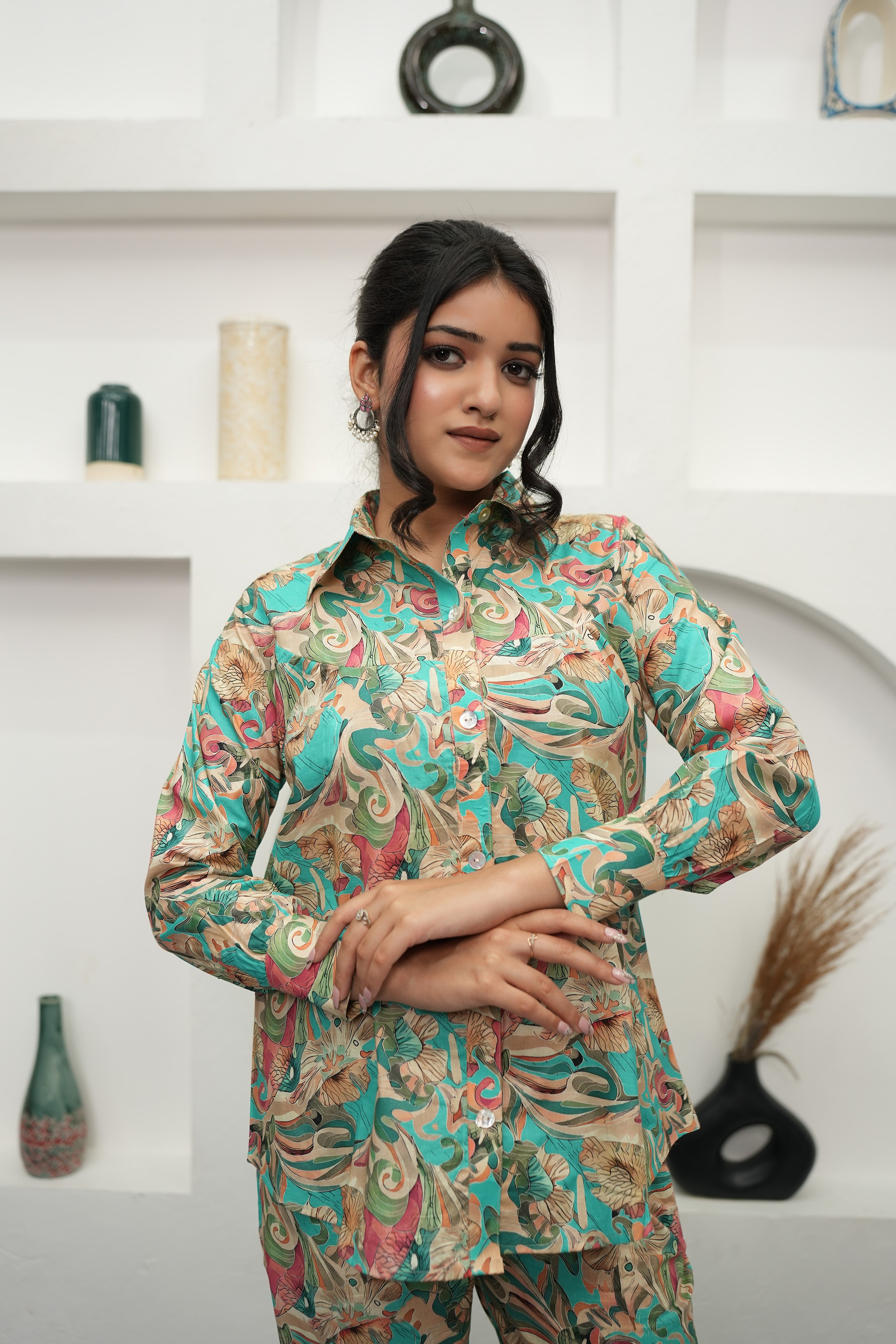 A woman is standing, wearing a teal and beige printed co-ord set with a floral pattern - Simroz.