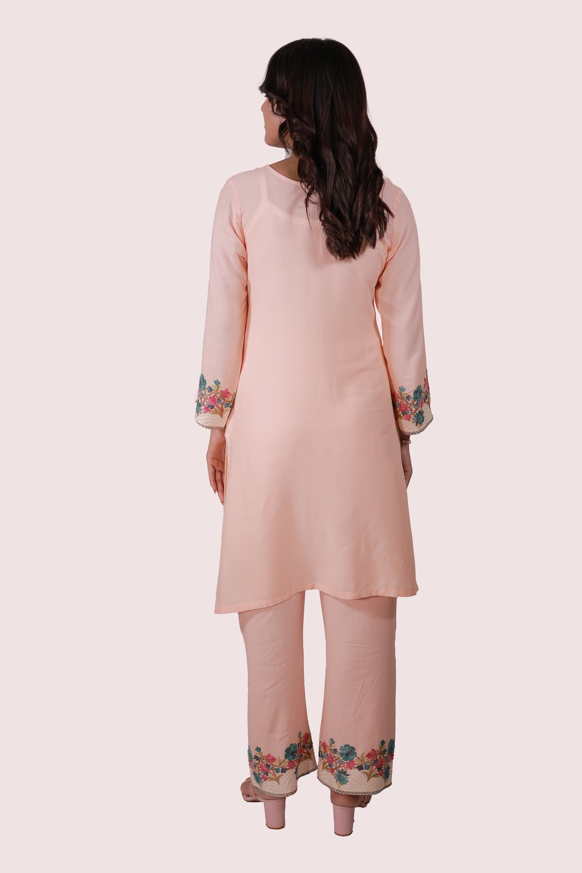 A woman wearing Simroz Bahaar-e-Gulmarg Kurta Set, Kashmiri Aari embroidery, Peach Orange – back view