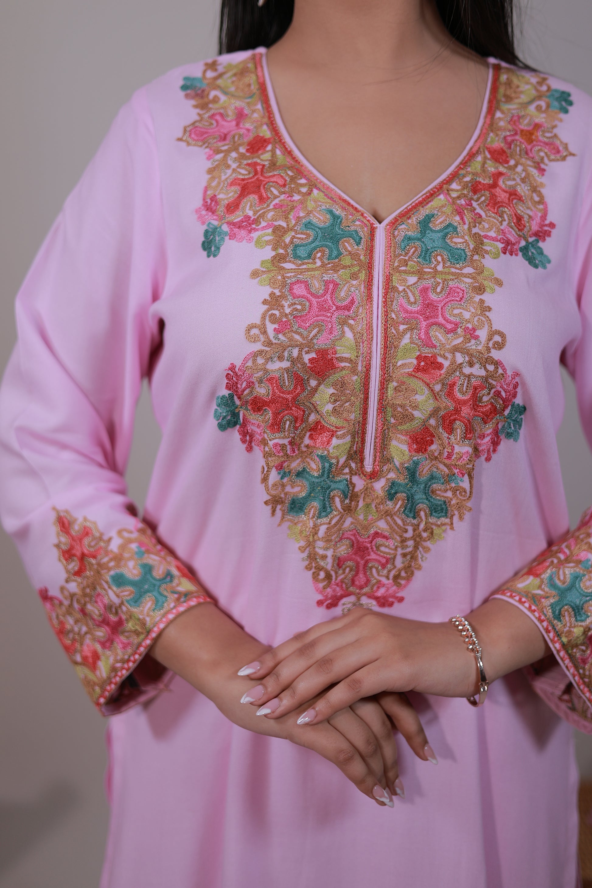 Close-up of Pastel Pink Kashmiri embroidered Gul-e-Kashmir Kurta Set by Simroz with intricate detailing on neckline and sleeves