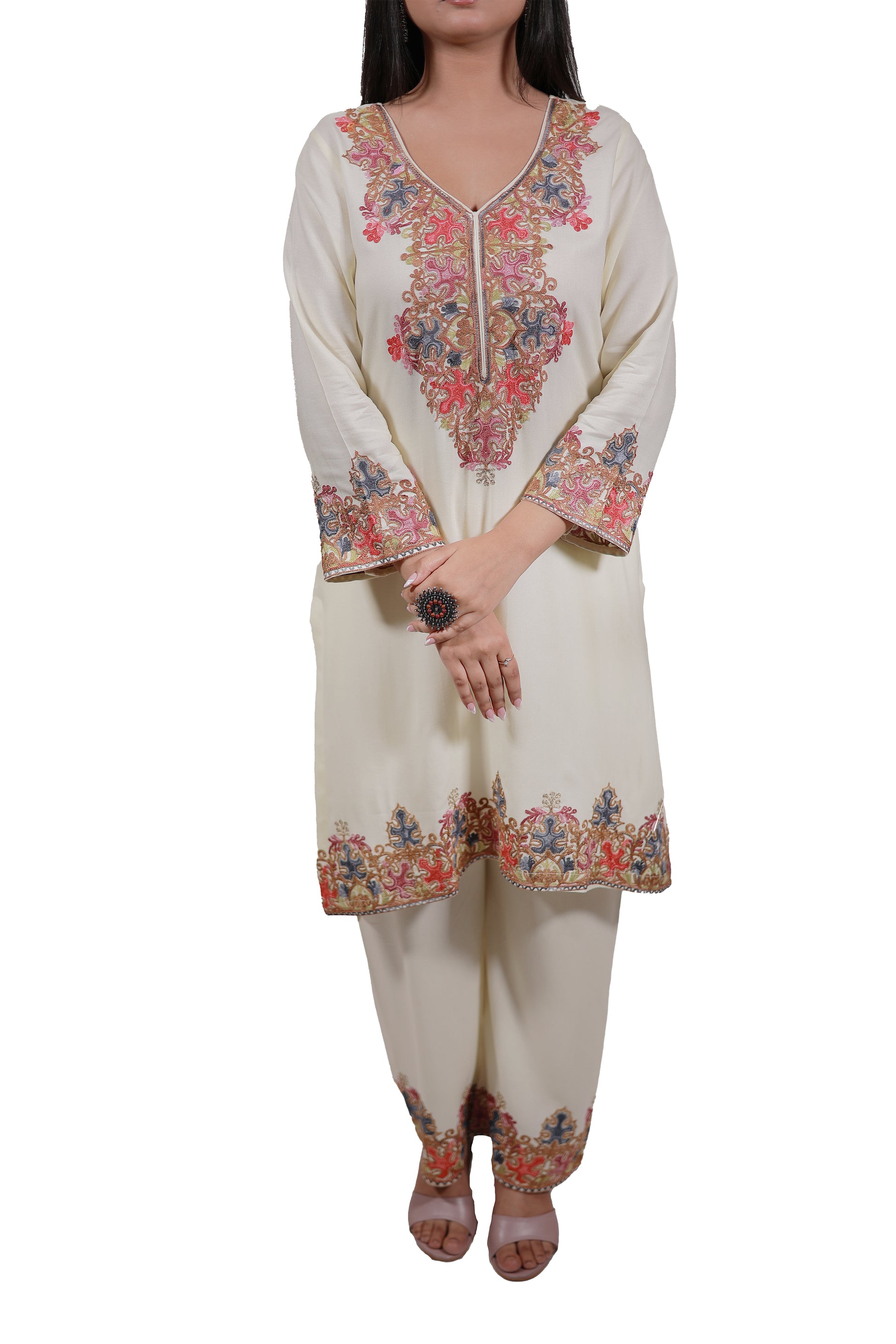 A model wearing Simroz Gul-e-Kashmir Kurta Set in pastel yellow with intricate Kashmiri Aari embroidery, perfect for festive occasions with matching bottoms - Simroz