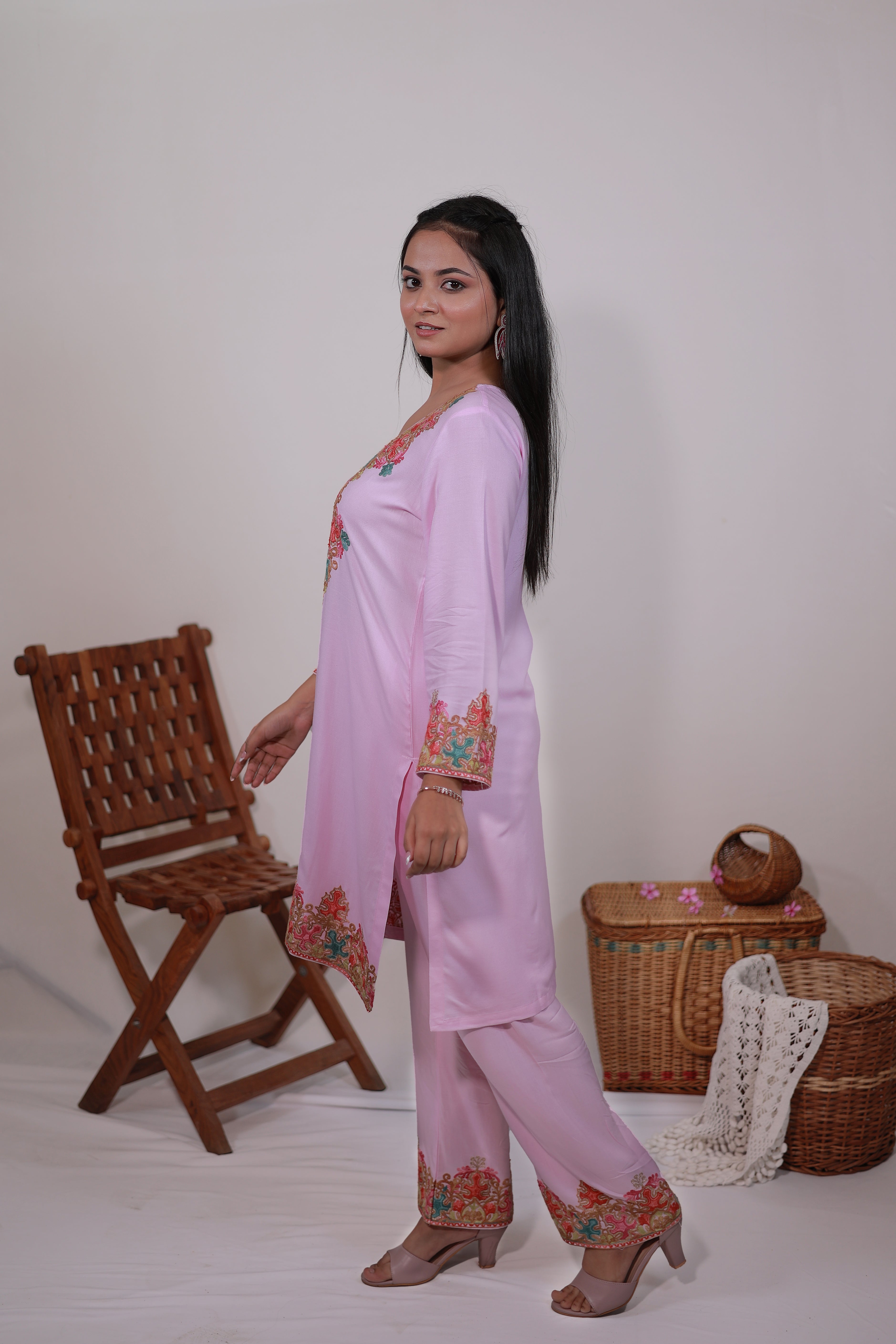Side pose of model wearing Simroz Pastel Pink Kashmiri Aari embroidered Kurta Set, rayon viscose straight-fit design