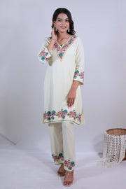 A woman wearing Simroz Bahaar-e-Gulmarg Kurta Set, Kashmiri Aari embroidery, Pastel Yellow – front view