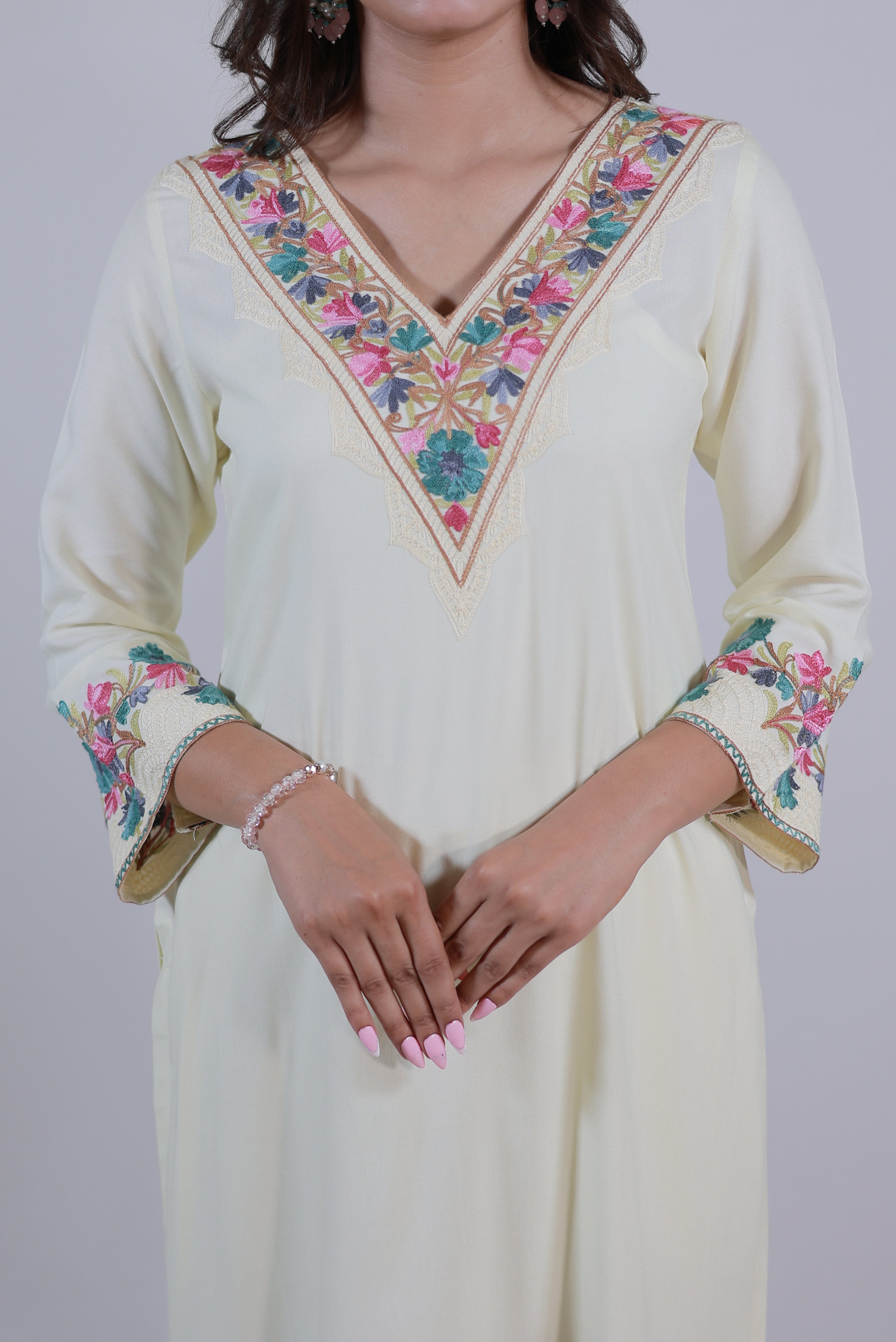 A woman wearing Simroz Bahaar-e-Gulmarg Kurta Set, Kashmiri Aari embroidery, Pastel Yellow – Close-up front view