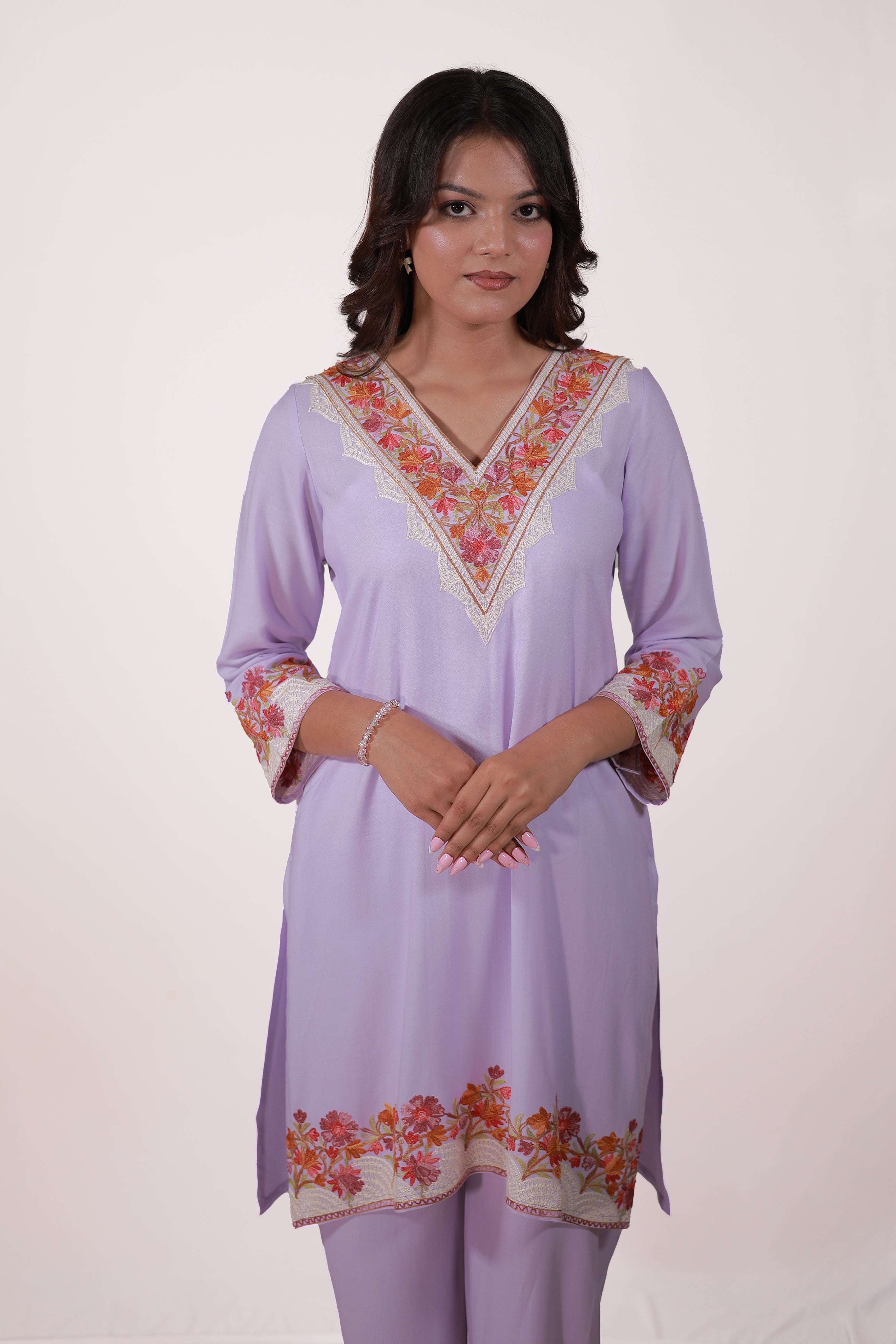 A woman wearing Simroz Bahaar-e-Gulmarg Kurta Set, Kashmiri Aari embroidery, Mauve color, relaxed pose - front view