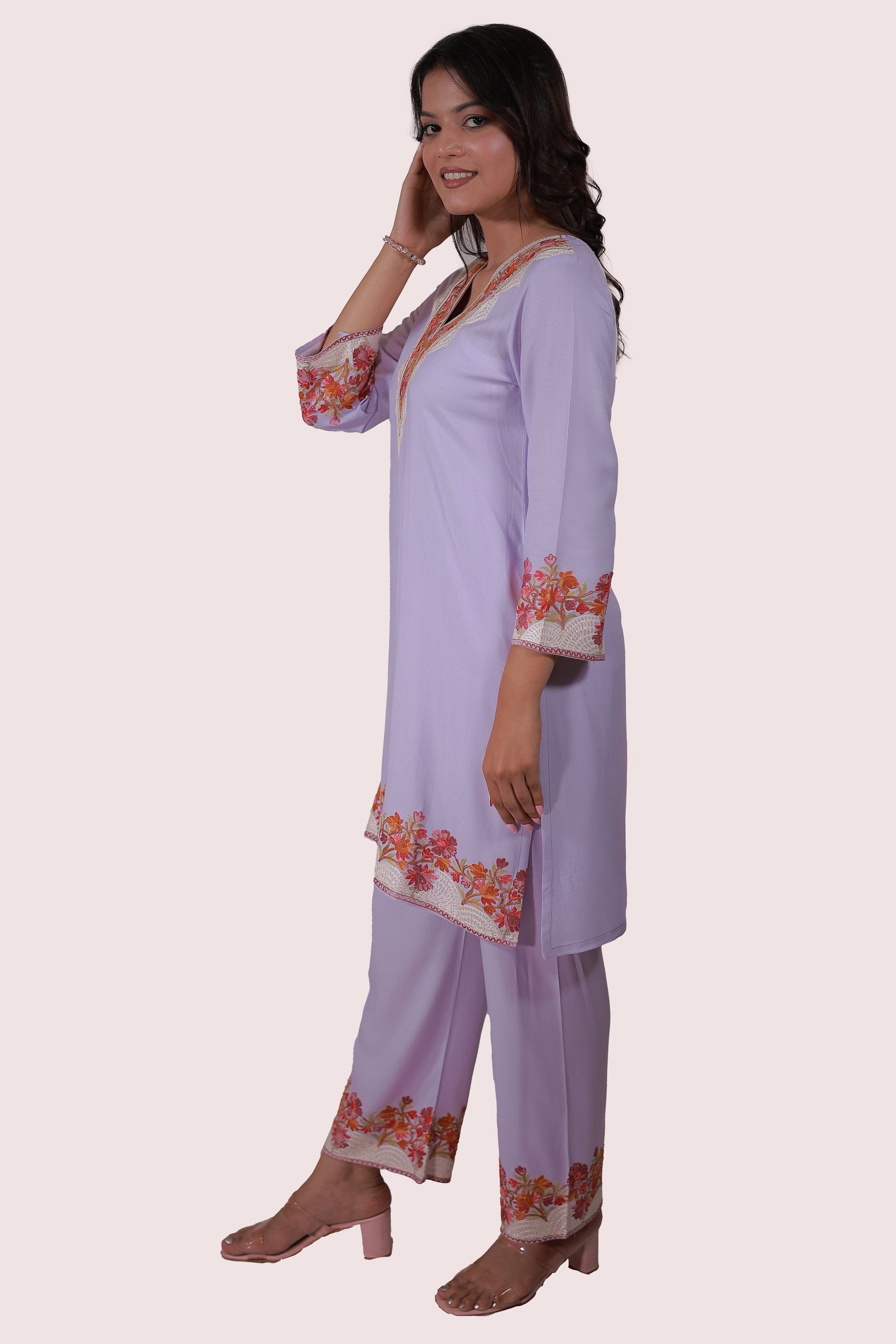 A woman wearing Simroz Bahaar-e-Gulmarg Kurta Set, Kashmiri Aari embroidery, Mauve color – side view pose