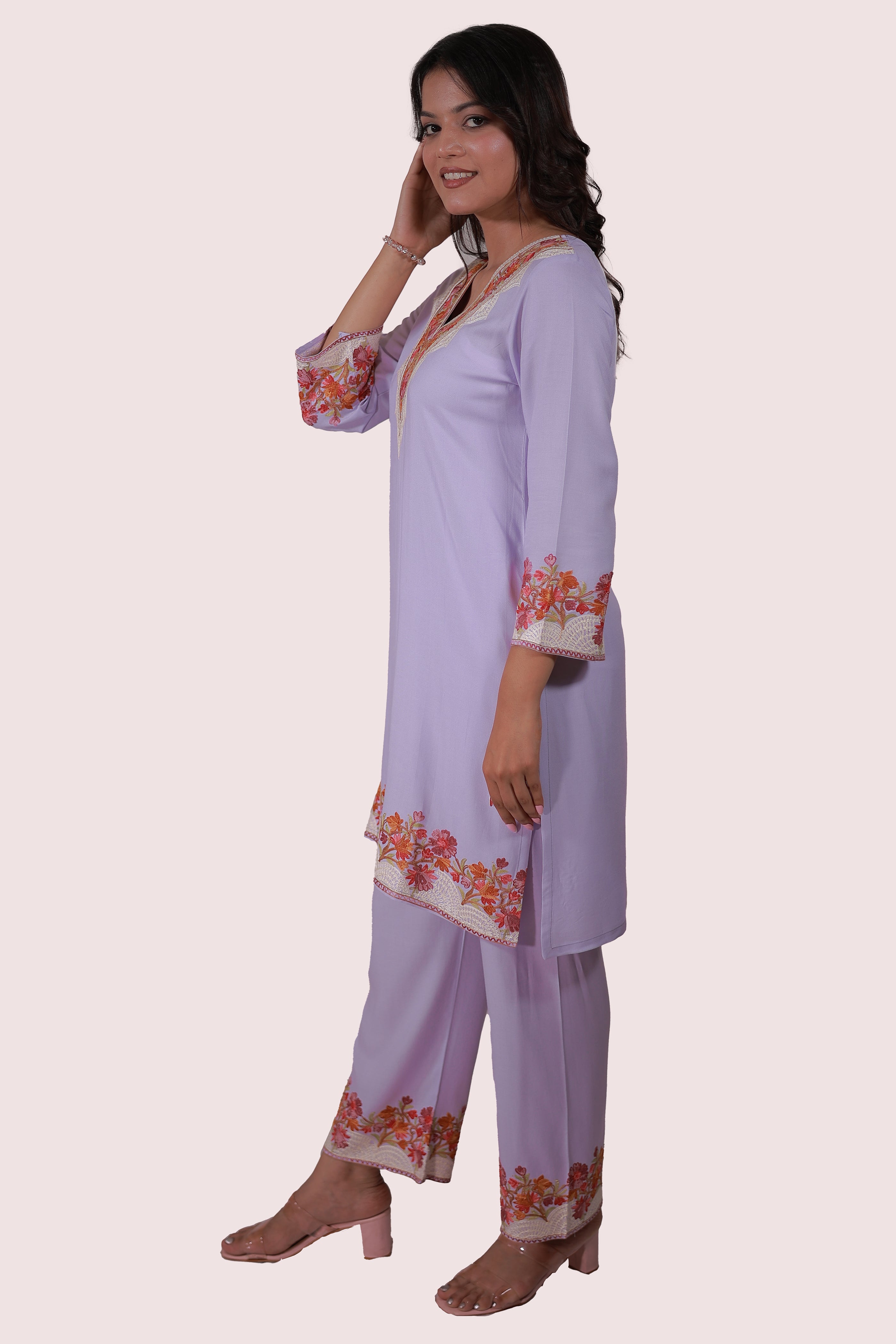 A woman wearing Simroz Bahaar-e-Gulmarg Kurta Set, Kashmiri Aari embroidery, Mauve color – side view pose