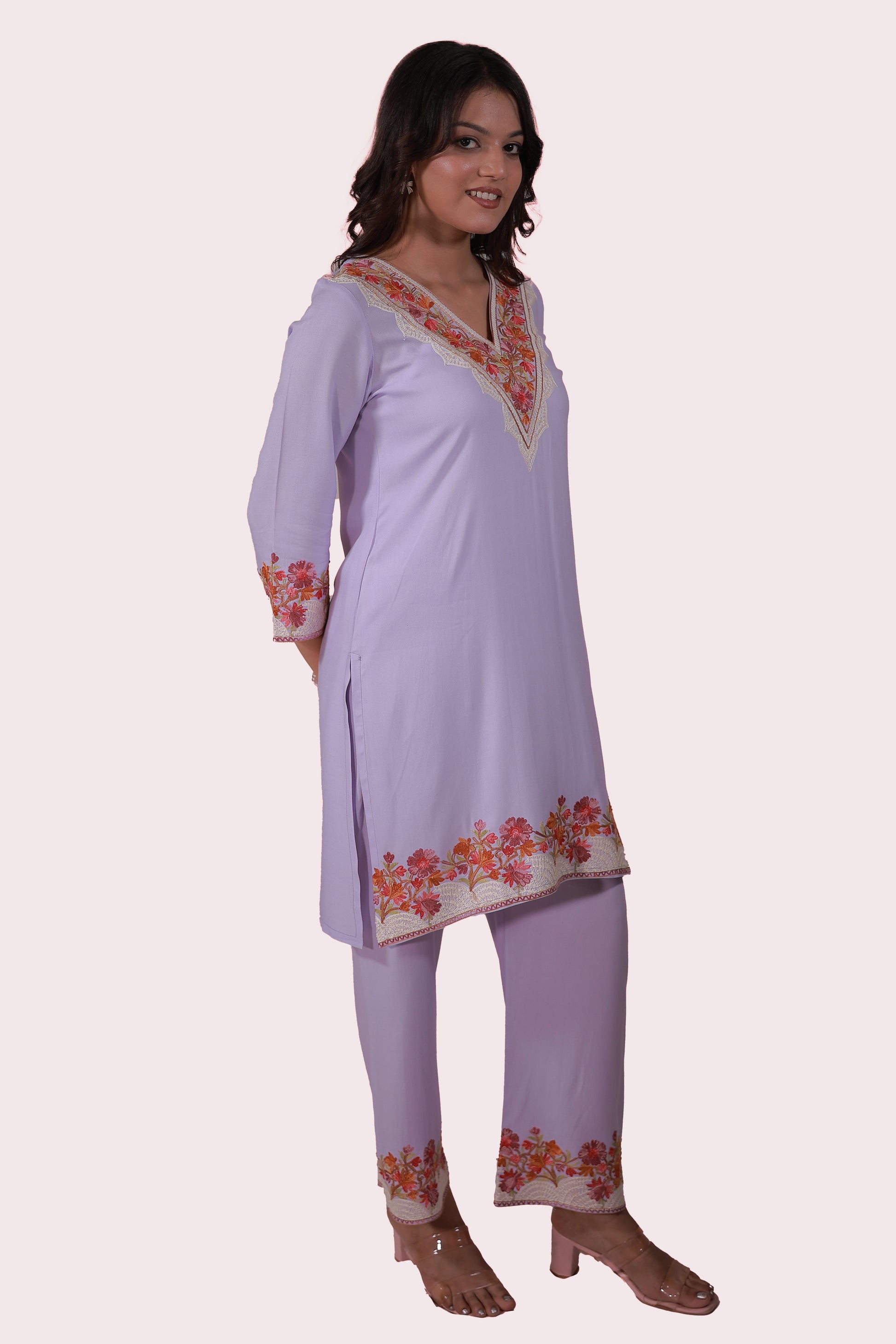 A woman wearing Simroz Bahaar-e-Gulmarg Kurta Set, Kashmiri Aari embroidery, Mauve color – side view relaxed.