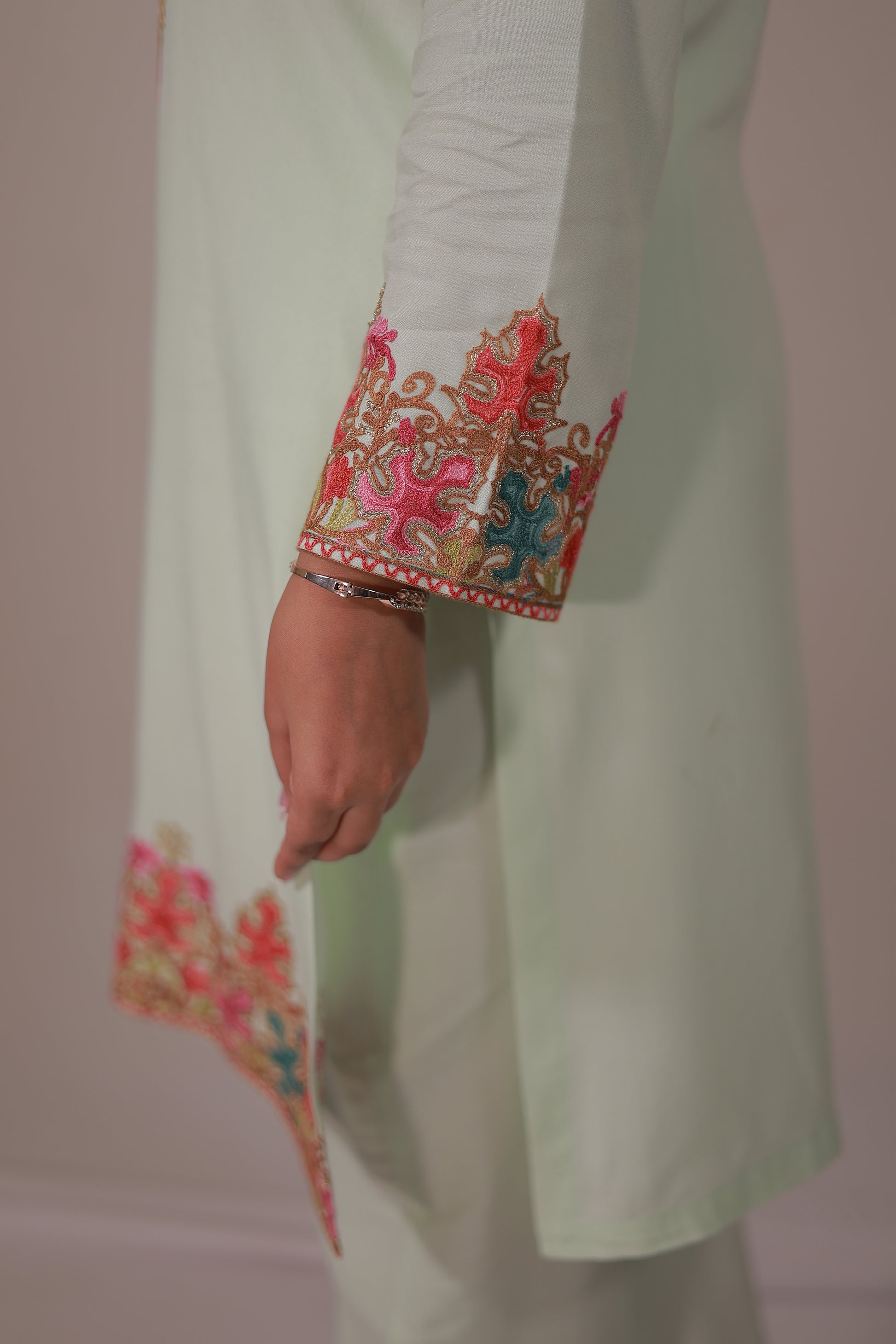 Side view of Simroz pastel green Kashmiri embroidered Kurta Set, rayon viscose straight kurta with matching bottoms