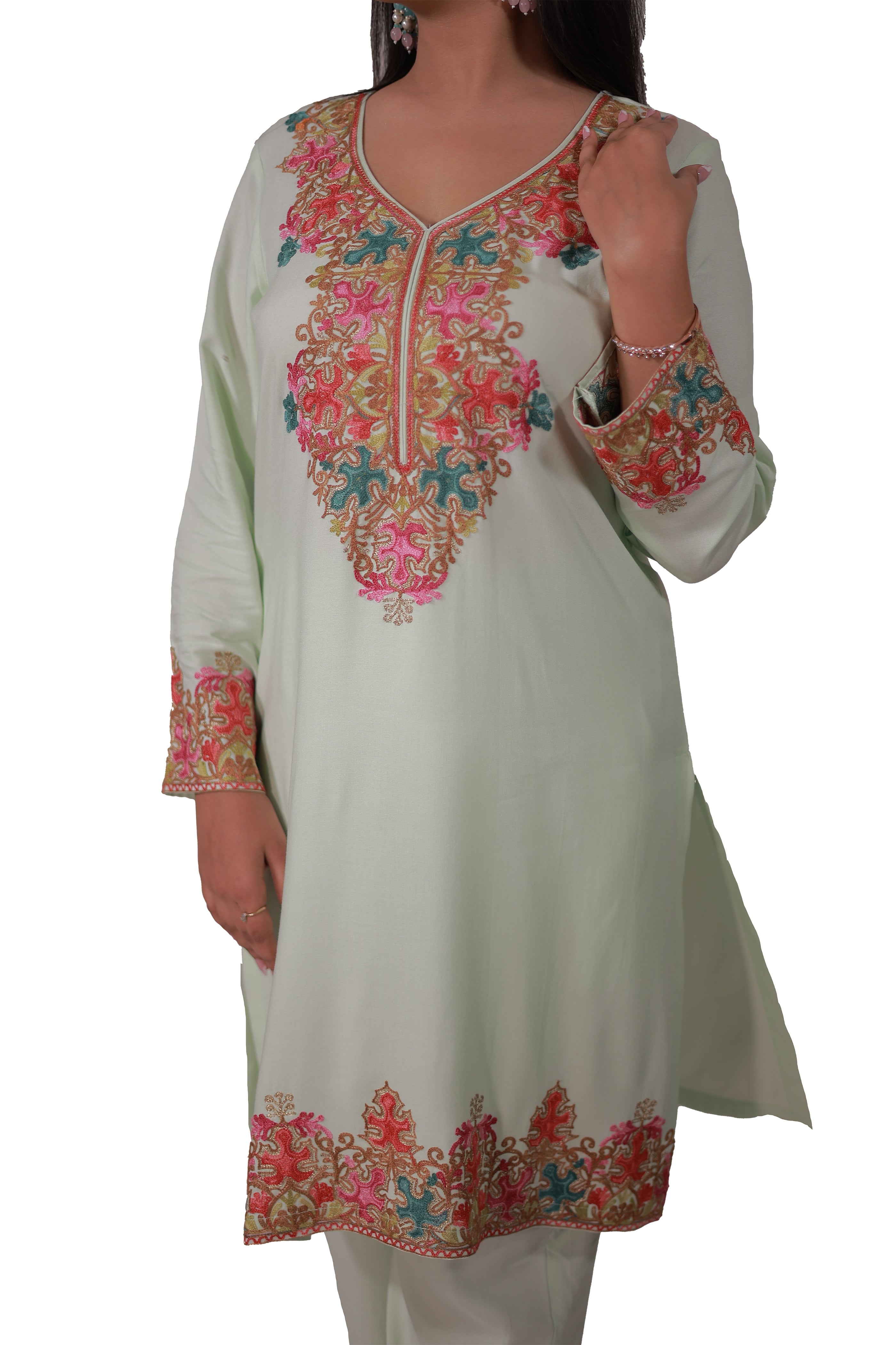 a woman wearing pastel green Gul-e-Kashmir Kurta Set with intricate Kashmiri Aari embroidery on neckline and sleeves - Simroz