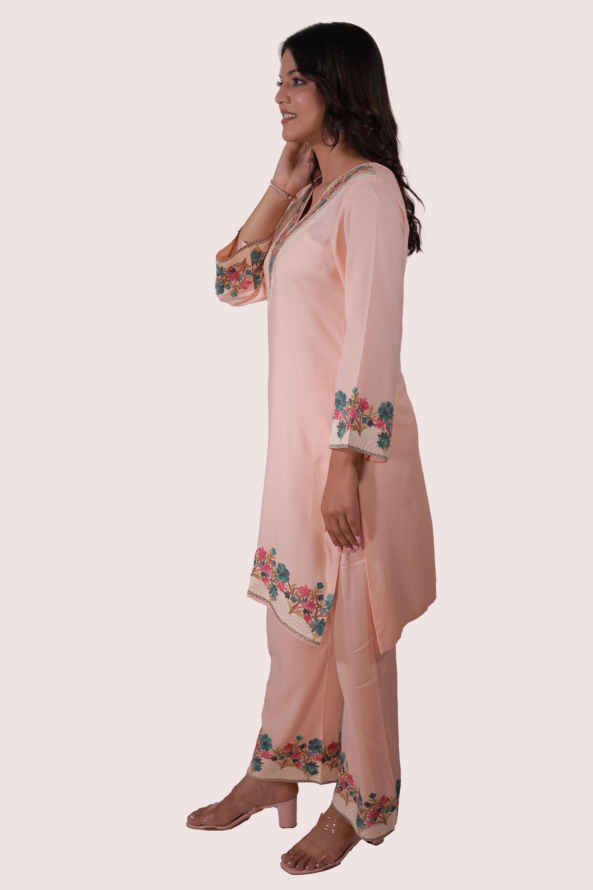 A woman wearing Simroz Bahaar-e-Gulmarg Kurta Set, Kashmiri Aari embroidery, Peach Orange – side view